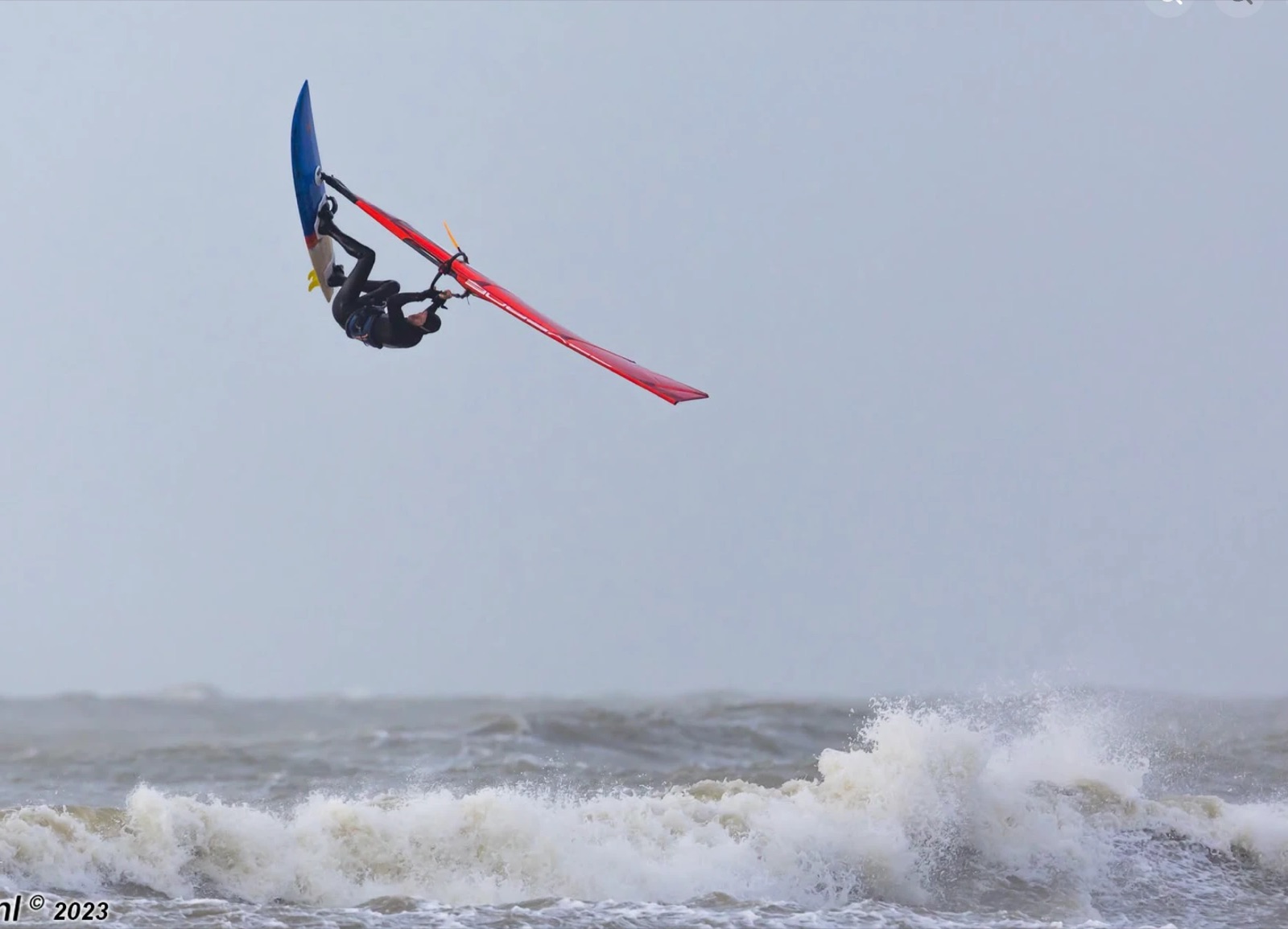 Reinoud throwing a forward loop windsurfing at Wijk aan Zee